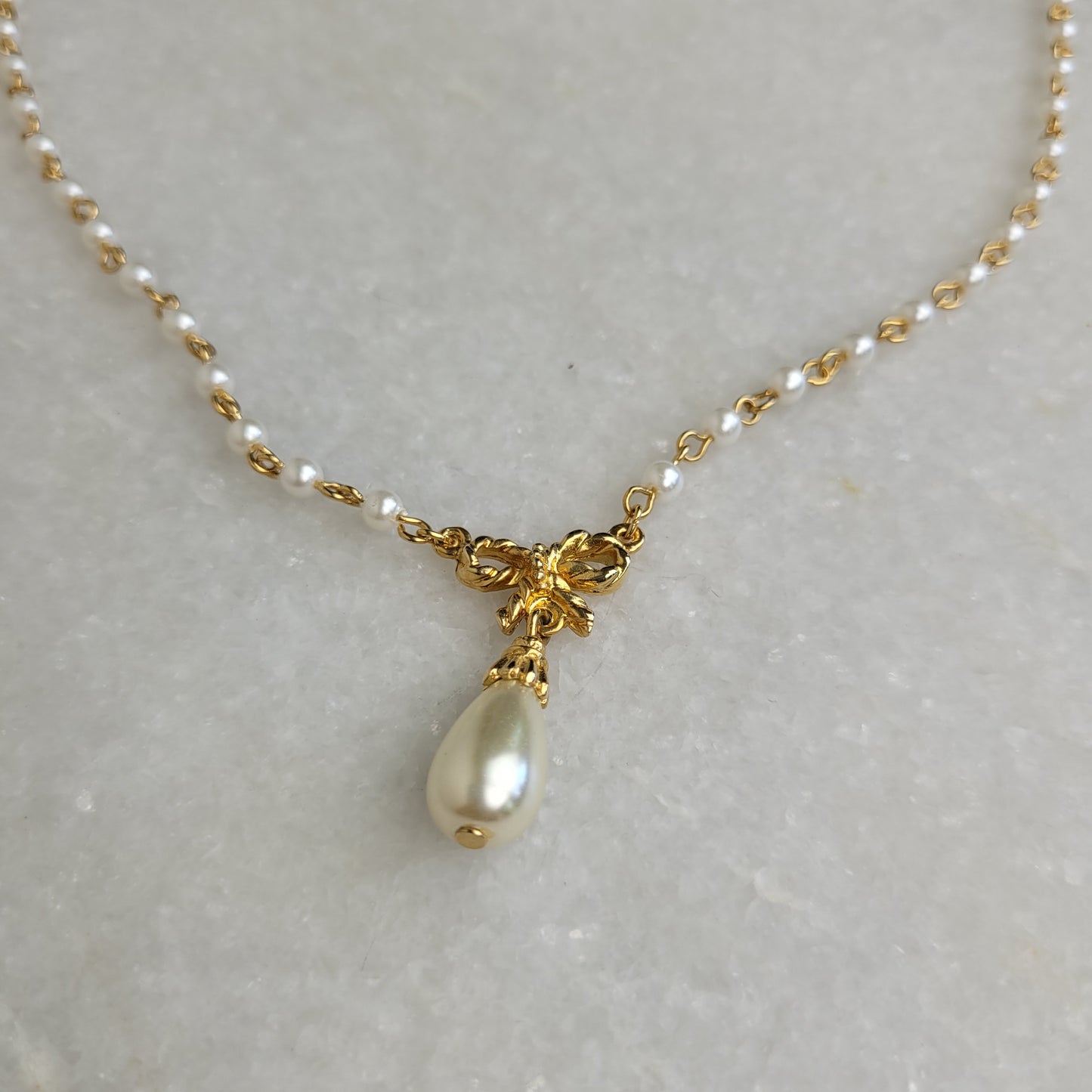 Gold Tone Faux Pearl Bow Pendant Necklace