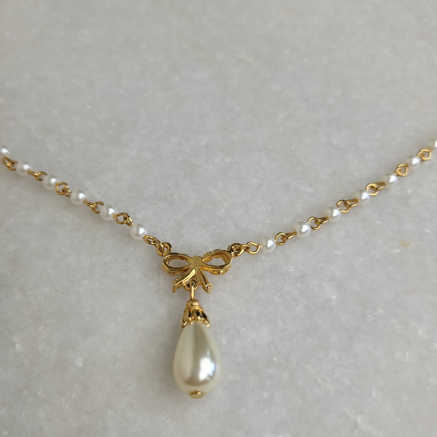 Gold Tone Faux Pearl Bow Pendant Necklace