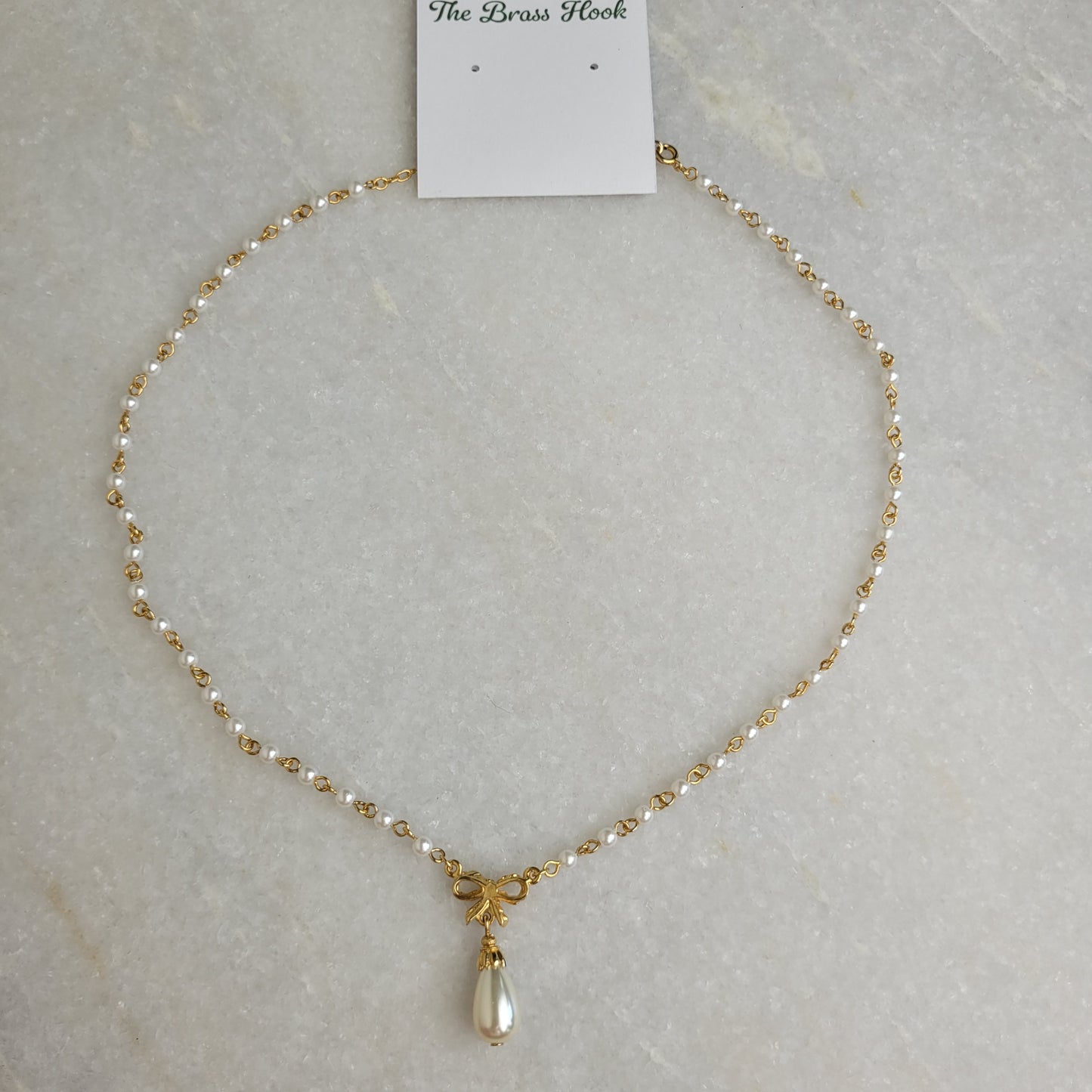 Gold Tone Faux Pearl Bow Pendant Necklace